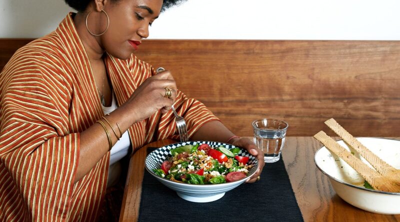 A female eating salad.