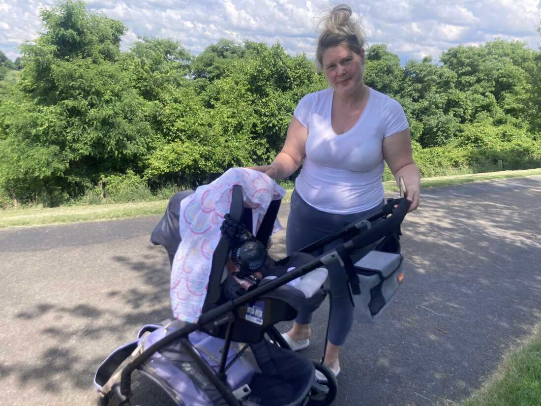 Molly Loveland and her daughter, Maya, in a park in Washington, Pennsylvania.  Loveland works at a nearby nursing home.  Loveland worries about catching COVID and bringing it home to her baby after she returns to work.  Government data shows that only 4 out of 10 US nursing home residents have received at least one dose of the latest COVID vaccine, which was released last fall.