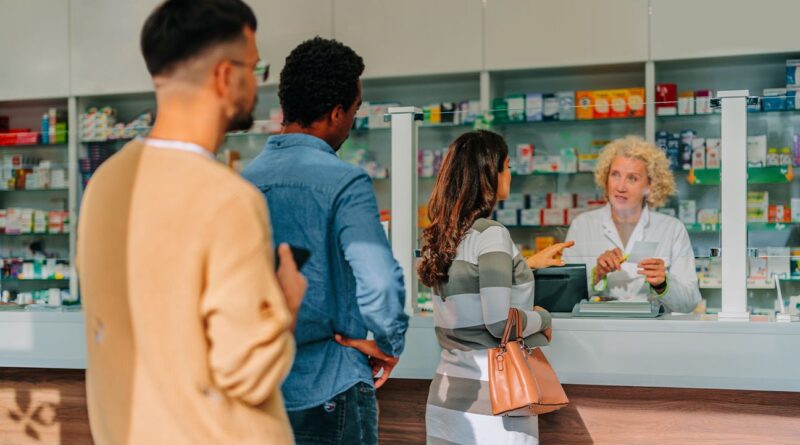 People are standing in line at the pharmacy.